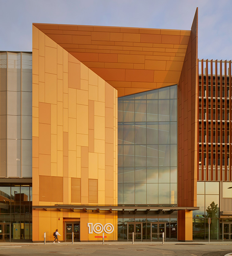 Entrance of 100 Hood Park with modern orange facade