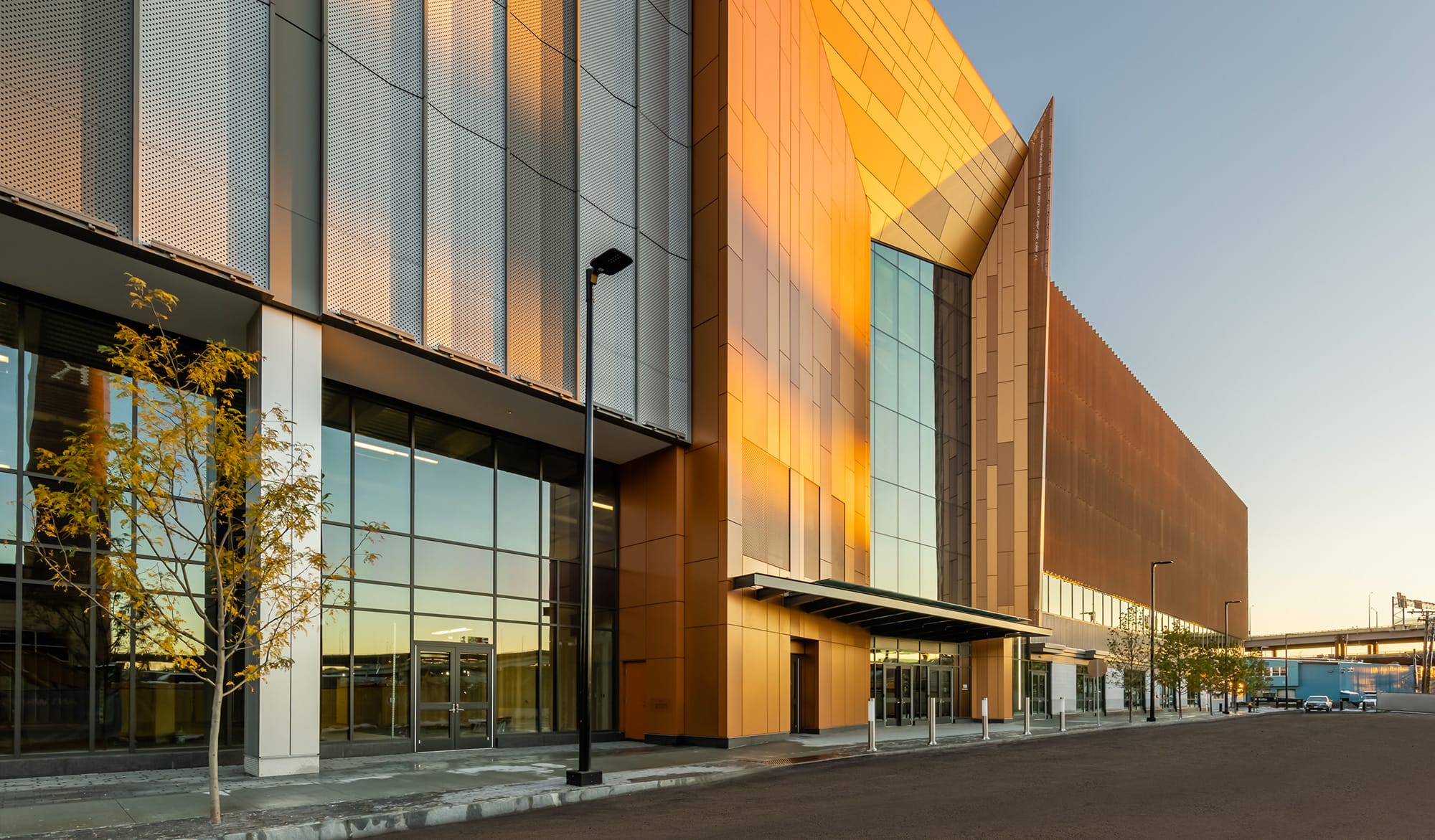 Side view of entrance to 100 Hood Park at sunset