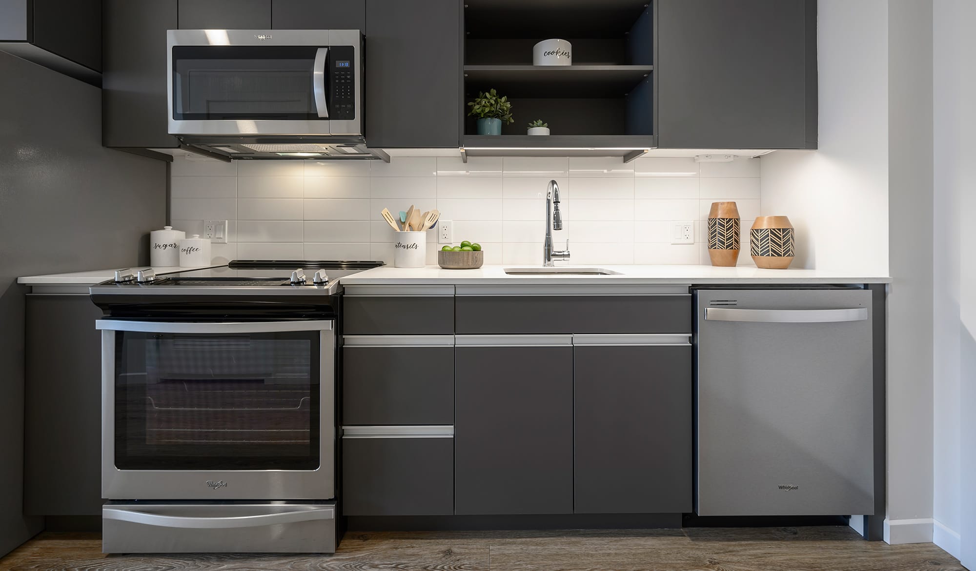 Kitchen with grey cabinets and stainless steel appliances